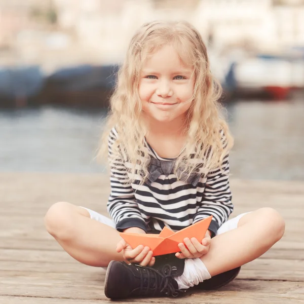 Girl playing with paper boat — Stock Photo, Image