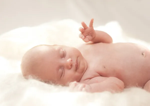 Baby girl sleeping on knitted cover — Stock Photo, Image