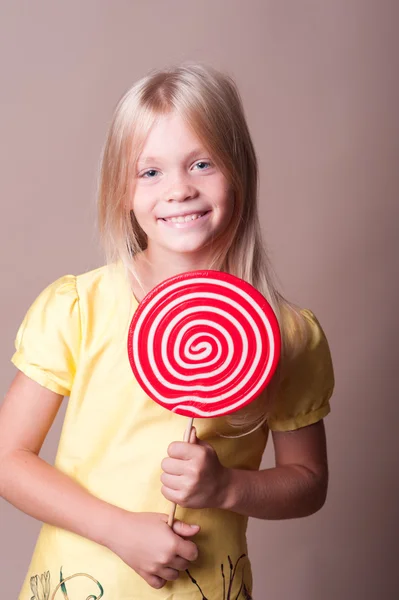 Girl eating round sweet — Stock Photo, Image