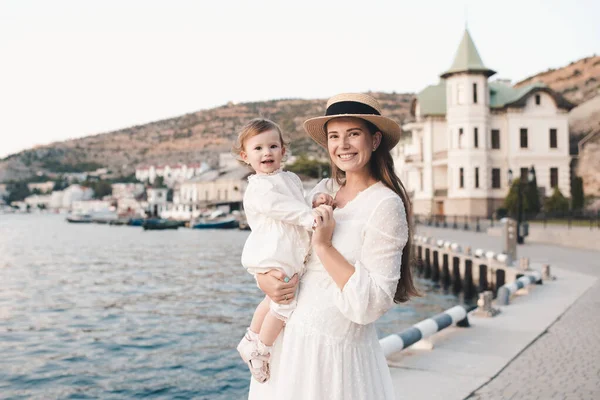 Happy Cheerful Baby Girl Sitting Mother Hands Wear Stylish White — Stockfoto
