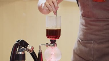 Professional baristas making coffee like a Siphon Coffee Maker. 4k Slow Motion video  (The submitted footage is a grouping shooting arrangement)
