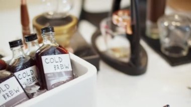Coffee shop corner with bottled cold brew coffee soaked in ice buckets. 4k Slow Motion video