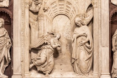 Sculptures carved in a marble wall representing the moment when the angel told May she would be the mother of God
