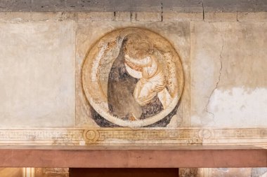 Religious medieval fresco in ruins showing Virgin Mary holding baby Jesus