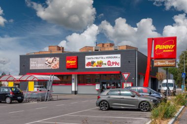 Fossano, Cuneo, İtalya - 10 Eylül 2021: Rewe Group 'a ait Alman kökenli Penny Market süpermarketi. Alışveriş arabası deposu olan dış bina manzaralı.