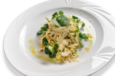 Kuzu marullu enginar salatası, parmesan gevreği ve beyaz tabaktaki ekstra saf zeytinyağı.