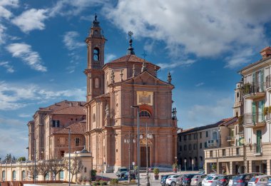 Fossano, Cuneo, İtalya - 27 Şubat 2022: Kutsal Üçleme Kilisesi veya dei Battuti Rossi (18. yüzyıl kemeri Francesco Gallo) barok tarzında, mavi gökyüzü bulutlu. Fossano İtalya 'nın kuzeybatısında.