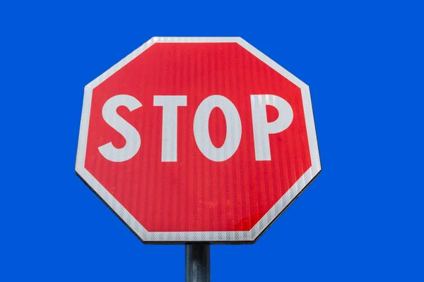 Traffic STOP sign on clear blue sky