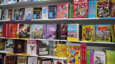 Fossano, Italy - July 26, 2022: Shelves for sale of books in Italian bookstore