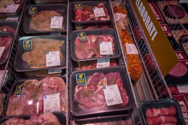 Fossano, Italy - July 29, 2022: ready-to-cook seasoned steaks in plastic food trays in refrigerated counter in Eurospin Italian supermarket. Tex: preparati qui per te (prepared here for you)