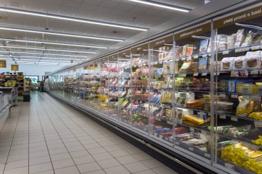 Fossano, Cuneo, Italy - August 02, 2022: Long refrigerator shelving with ready-to-eat foods and salami packaged in Italian supermarket tex: piatti pronti (ready to eat)