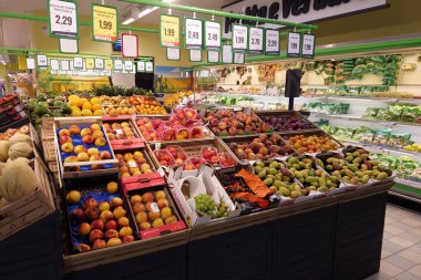 Fossano, Italy - August 30, 2022: stalls with fruit and vegetables in italian supermarket Eurospin, summer fruit in boxes displayed for sale with prices in euros