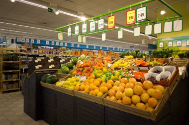 Fossano, Italy - August 30, 2022: stalls with fruit and vegetables in italian supermarket Eurospin, fruit in boxes displayed for sale with prices in euros