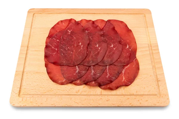 Bresaola slices, italian dried beef salami from Valtellina on wooden cutting board isolated on white