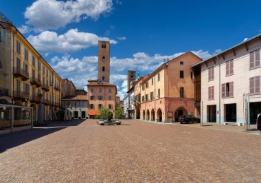 Alba, Langhe, Piedmont, Italy - August 16, 2022: Piazza Risorgimento historic center of the city with the town hall, the arcades and the medieval towers of the age of the communes