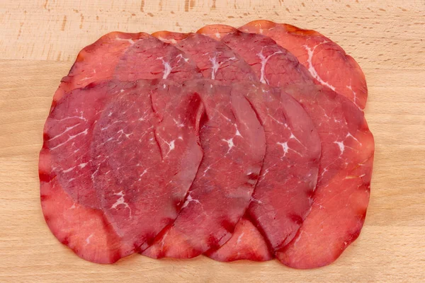 Bresaola片 意大利干牛肉腊肠从Valtellina木制背景 — 图库照片