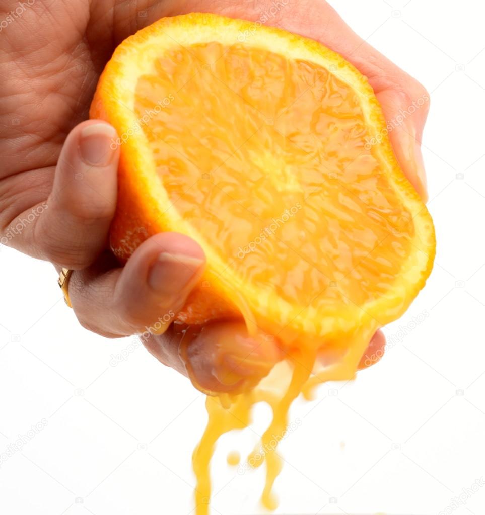 Hand squeezing an orange