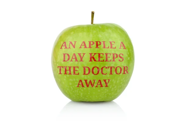 Studio shot of green apple with inscription doctor away — Stock Photo, Image