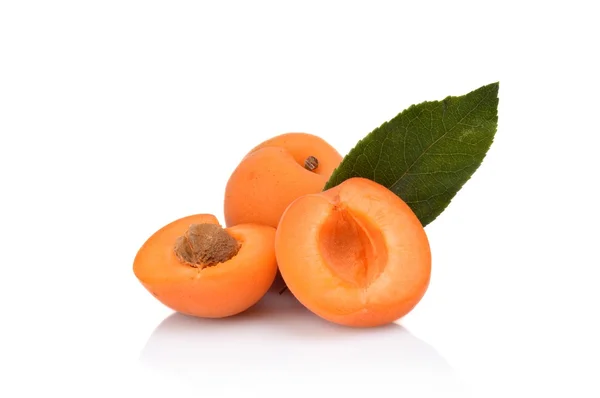 Three sliced apricots with leaf isolated on white — Stock Photo, Image