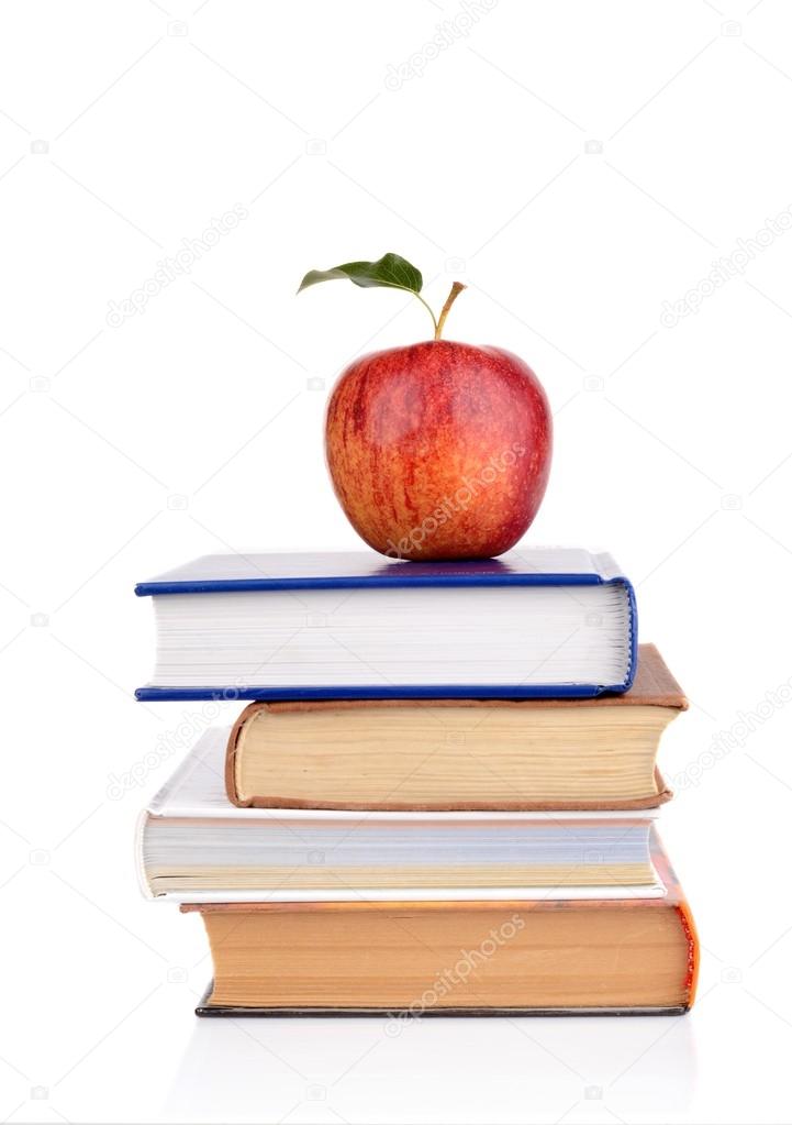 Apple on few school books isolated on a white background