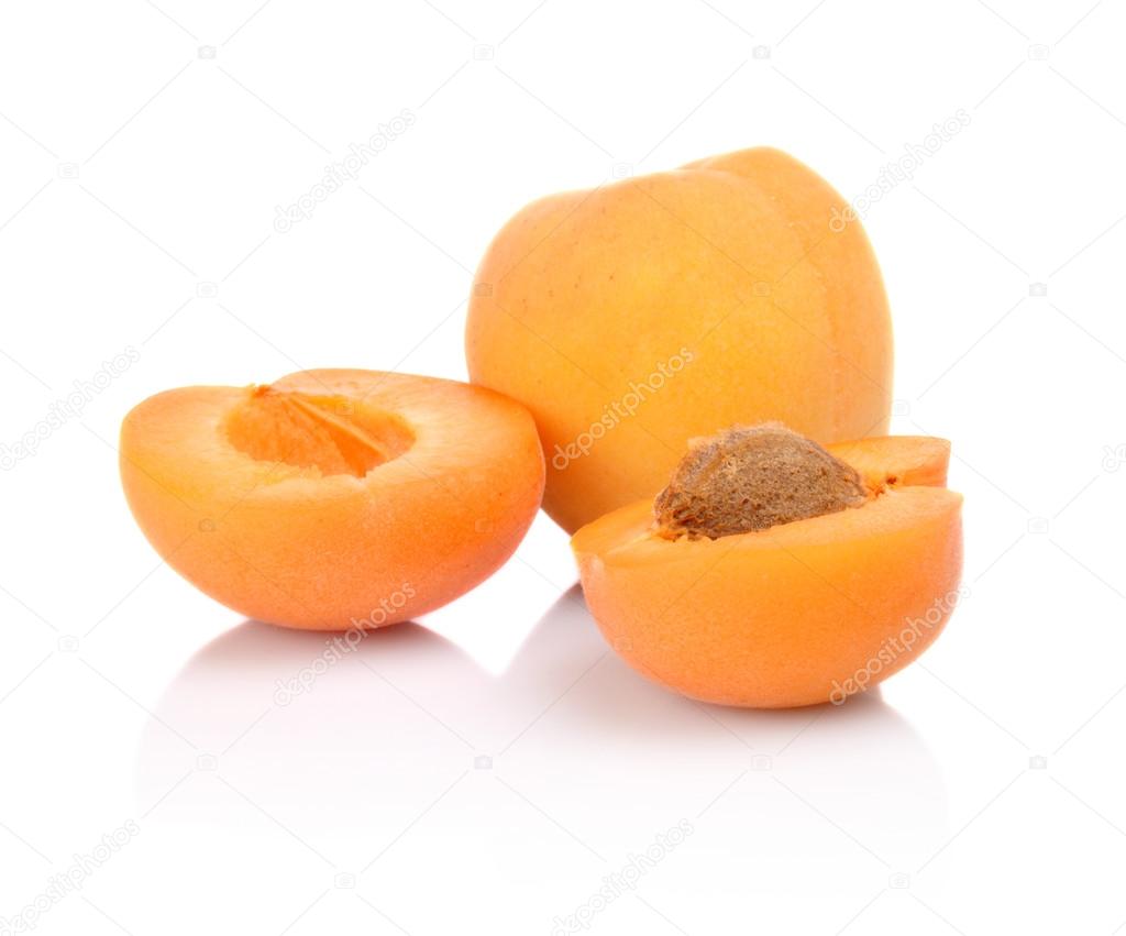 Three sliced apricots isolated on white