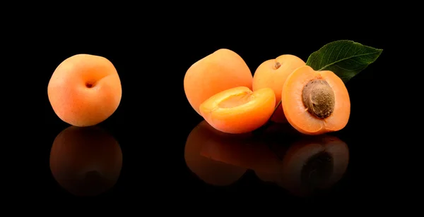 Three sliced apricots isolated on black — Stock Photo, Image