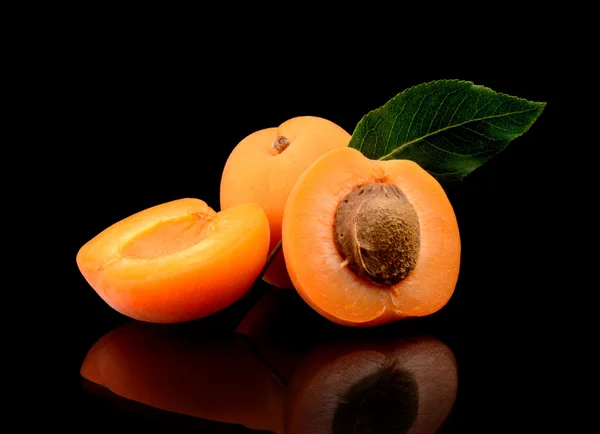 Three sliced apricots isolated on black — Stock Photo, Image