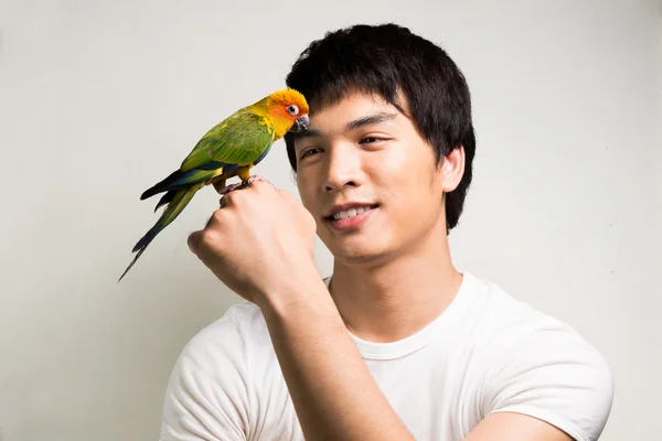 Asian men with parrot - Sun Conure — Stock Photo, Image