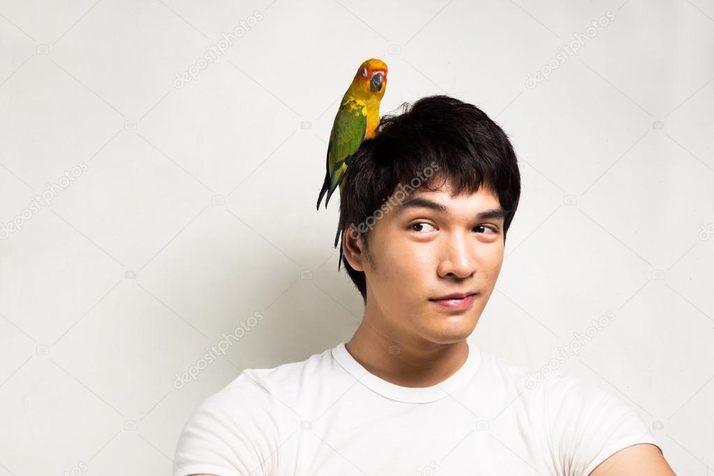 Asian men with parrot - Sun Conure