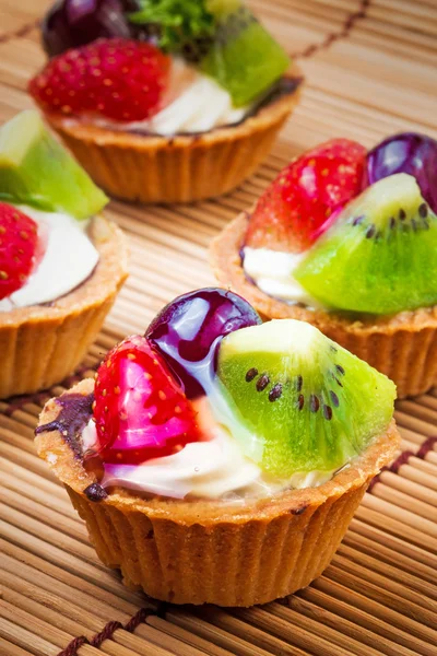 Mini frukt tårta och trä bakgrund — Stockfoto