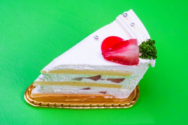 Strawberry cream cake in green background — Stock Photo, Image