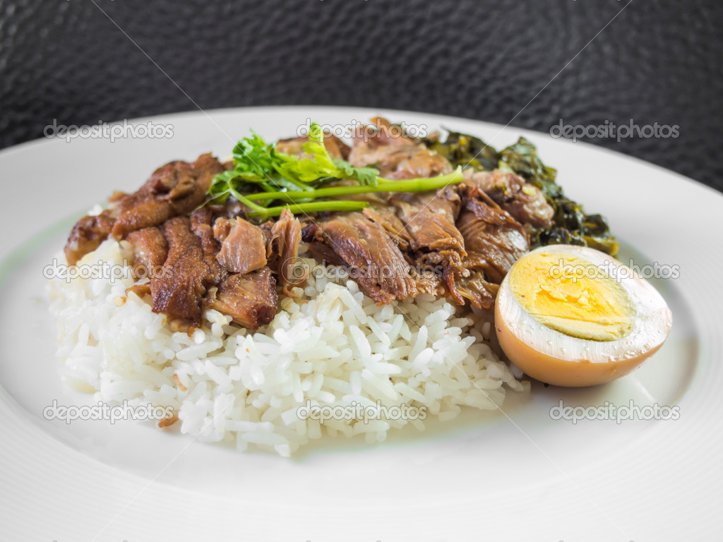 Stewed pork leg on rice with boiled egg and preserve