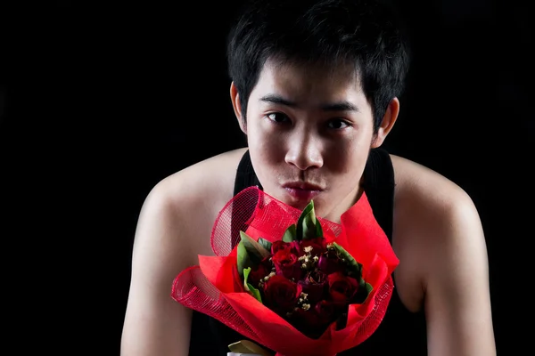 Asian boy with red bouquet in dark background — Stock Photo, Image