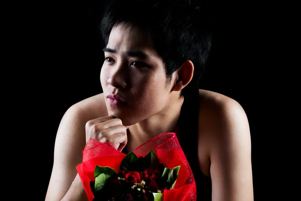 Asian boy with red bouquet in dark background — Stock Photo, Image