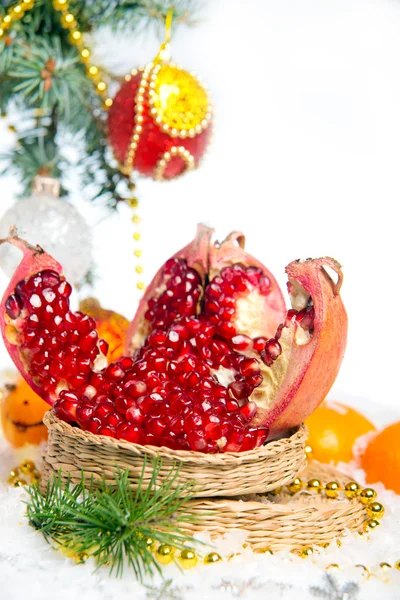 Fresh pomegranate. Christmas decorations for the Christmas tree on a wooden table. — Stock Photo, Image