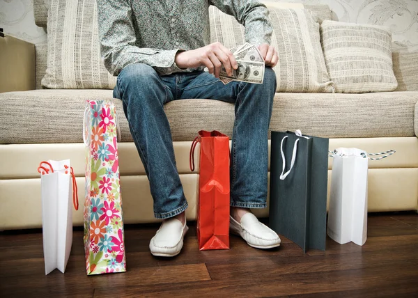 Man in shop with packages. — Stock Photo, Image