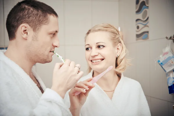 Young couple working at home in bed — Stock Photo, Image