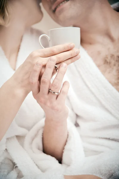 Young couple working at home in bed — Stock Photo, Image