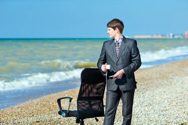 Een man die werkt op een computer buiten. — Stockfoto