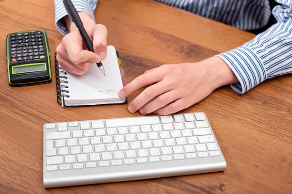 Young man working on a computer keyboard — Stock Photo, Image