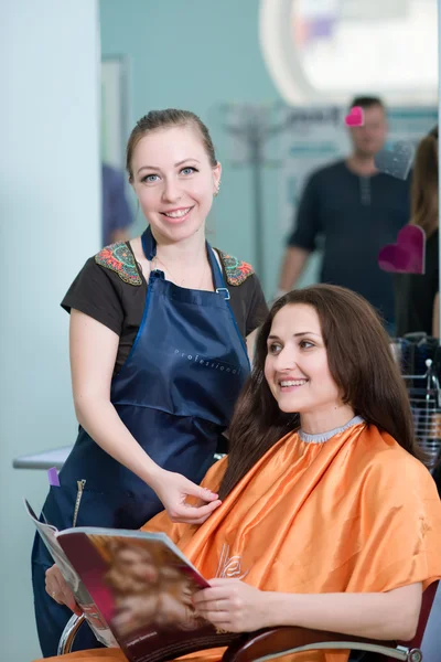 Felice giovane donna ottenere un nuovo taglio di capelli da parrucchiere in salotto — Foto Stock