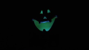 Siyah arka planda balkabağı feneri. Geleneksel olarak balkabağı ya da şalgamdan oyulmuş fener. Korkunç ya da komik suratlı bir kafa. Balkabağı feneri. Will-o-peruk. Parlayan ve parlayan ışık.