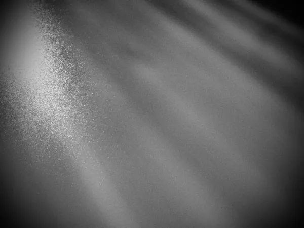 Abstract gray background. Oblique light rays on a gray background with flickering dots. From left to top, the lines are directed down and to the right. Coarse grain. Glow, flare or shine. — Stock Photo, Image