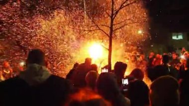 Sremska Mitrovica, January 6, 2022 Burning of the sacred oak tree at the stake in front of a crowd of people. Celebrating Christian Orthodox Christmas. Sparks fly to the believing parishioners.