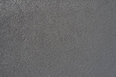 Gri arka plan. Alçıyla kaplanmış gri ya da siyah duvar. Sert bir doku. Kadife etkisi. Duvarların, iç mekanların, binaların ve binaların ön cephelerinin profesyonelce bitirilmesi. İnşaat ve tasarım.