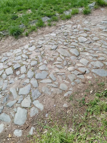 Paving stones - a hard road surface, a kind of pavement, lined with flat rectangular bars of the same shape and size. Block stone from which the road surface was built. Petrovaradin, Novi Sad, Serbia.