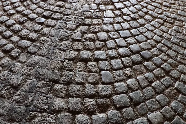 Paving stones - a hard road surface, a kind of pavement, lined with flat rectangular bars of the same shape and size. Block stone from which the road surface was built. Petrovaradin, Novi Sad, Serbia.