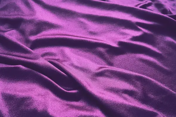 Velour fabric, similar to silk. Textiles in a folds and beautiful waves. Purple, pink, magenta shades on the drapery. Sewing material for evening dresses, furniture upholstery, curtains and interior. — Stock Fotó