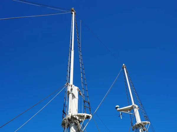 Un albero, una struttura verticale su una nave sostenuta da bretelle, i cosiddetti watt, parte dell'armamento a vela su barche a vela. Attrezzature sportive per la regata. Sfondo di un cielo blu — Foto Stock