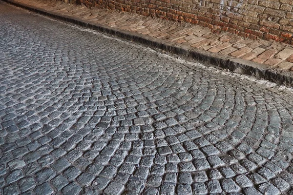 Paving stones - a hard road surface, a kind of pavement, lined with flat rectangular bars of the same shape and size. Block stone from which the road surface was built. Petrovaradin, Novi Sad, Serbia — Zdjęcie stockowe